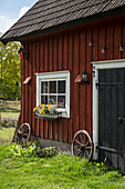 Outbuilding with transom window and flower box