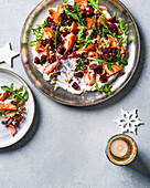 Hot smoked salmon with roasted beets and rocket on a serving platter (Christmas)
