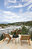 Seating area on curved viewing platform with harbour view