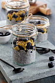 Chia dessert with passion fruit and blueberries in a jar