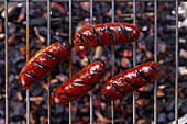 Grilled chorizo on a grill rack