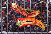 Grilled red pointed peppers on a grill rack