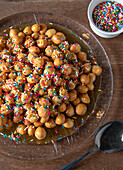 Struffoli - fried sweet dough balls in honey for carnival from Campania (Italy)
