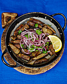 Veal liver with red onions, parsley, sumac, and piyaz salad