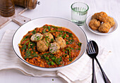 Red lentil dal with spinach and fried rice balls