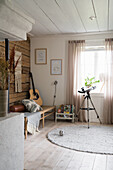 Cozy room with guitar, telescope and wooden accents