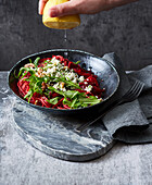 Beetroot pasta with feta cheese and rocket salad