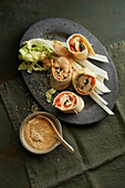 Rolls with kimchi chicken filling and peanut dip