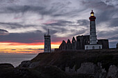 Sunset at Saint Mathieu Lighthouse with ancient ruin below the lighthouse tower, Finistere, Brittany, France, Europe