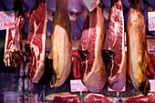 Cured ham (Jamon Iberico) hanging at market, Madrid, Spain, Europe