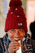 Smiling portrait of a woman drinking tea, Nepal, Asia