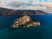 Aerial drone view of Spinalonga, deserted leper colony with fortifications, currently a tourist attraction, Crete, Greek Islands, Greece, Europe