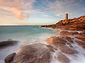 Sunset long exposure at Ploumanach lighthouse with the pink granite coast, Cotes d'Armor, Brittany, France, Europe