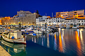 View of boats in marina overlooked by whitewashed buildings at dusk, Ciutadella, Menorca, Balearic Islands, Spain, Mediterranean, Europe