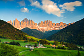 Sunset over the Odle peaks and the alpine village of Santa Magdalena in spring, Funes Valley, South Tyrol, Italy, Europe