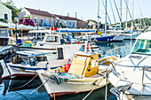 Fishing boats moored in the picturesque harbor of Fiskardo, Kefalonia, Ionian Islands, Greek Islands, Greece, Europe