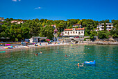 View of people swimming in the harbour at Ika, Ika, Kvarner Bay, Eastern Istria, Croatia, Europe