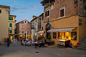 View of cafes. restaurants and shops at dusk in Lovran village, Lovran, Kvarner Bay, Eastern Istria, Croatia, Europe