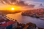 View of sunset over terracota rooftops and Douro River in the old town of Porto, Porto, Norte, Portugal, Europe