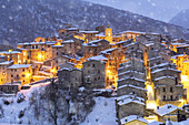 The illuminated medieval village of Scanno under snowfall, Abruzzo National Park, L'Aquila province, Abruzzo, Italy, Europe