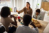 Mothers and sons eating breakfast and using phone