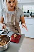 Woman weighting dough