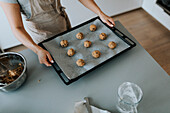 Woman in kitchen preparing cookies