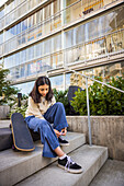 Girl skateboarder tying shoes