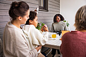 Family sitting at table outdoors