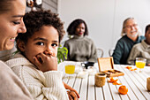 Family sitting at table outdoors