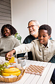 Family sitting at table outdoors