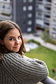 Portrait of teenage girl on balcony