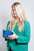Young woman looking at wallet