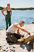 Men doing carpentry at water