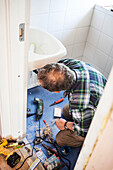 Man repairing bathroom sink
