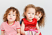 Portrait of three young sisters with curly hair