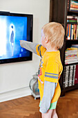 Boy pointing at TV
