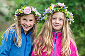 Smiling girls wearing flower wreaths