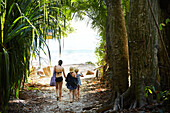 Mother with daughters walking at beach