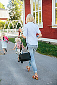 Mother walking with daughters