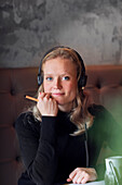 Portrait of young woman wearing headphones