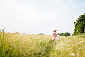 Girls running in meadow