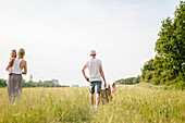 Family walking in meadow