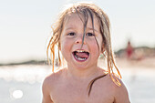 Portrait of smiling girl by sea