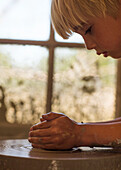 Blond boy working with clay