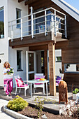 Woman on veranda of small house