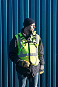 Worker standing next to container