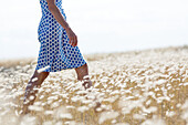 Woman walking through meadow