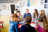 Teenagers talking in classroom