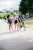 Teenagers with bicycle walking in city